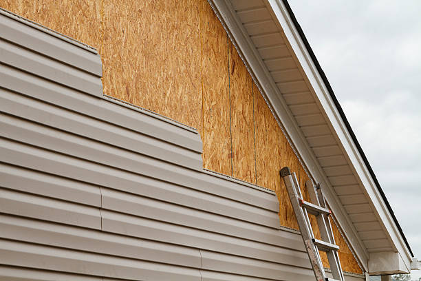 Professional Storm Damage Siding Repair technician working in South Hamilton, MA